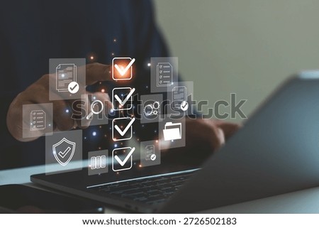Digital checklist document management concept. Approval process, data verification, workflow automation technology, cybersecurity, business compliance. Man using laptop with virtual interface icons