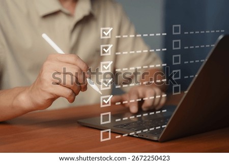 Digital checklist and task management concept. Person using a pen with a laptop to tick off items on a virtual checklist, symbolizing productivity, workflow, project planning and efficiency tools.