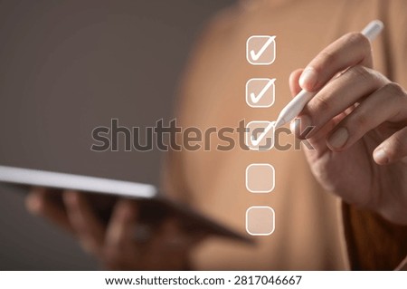 Digital checklist and task management concept featuring a hand marking completed items on a virtual checklist, workflow organization, goal achievement, quality control, compliance verification.