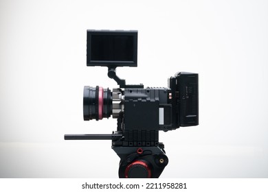 Digital Cinema Camera On A Tripod With A Rehoused Vintage Cine Lens White Background