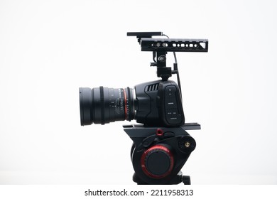 Digital Cinema Camera On A Tripod With An 35mm F1.4 Wide Angle Cine Lens White Background 4k