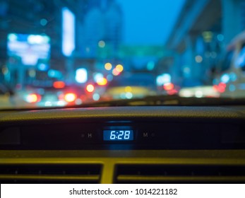 Digital Clock Inside Sedan Car In Evening Twilight Time In Bangkok Road, Thailand