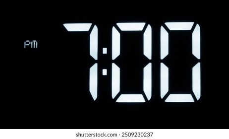 Digital clock on black background Showtime 07:00 pm.