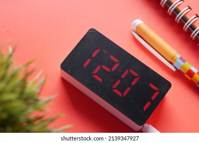 digital clock on red background top down 