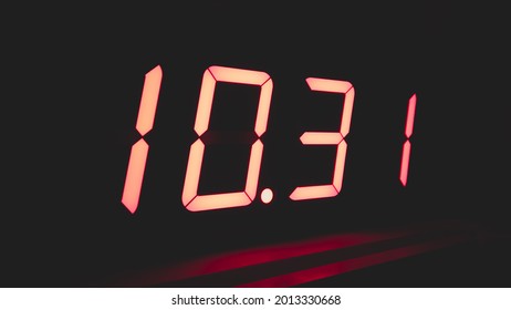 Digital clock with red led light illumination numbers in the dark. electronic timer with digits 1031