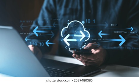 Digital cloud with arrows representing data transfer, held by a user with a smartphone and laptop, on a dark background. Concept of cloud storage
