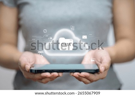 Digital cloud with data folder icon floating above smartphone, concept of cloud computing, storage, and data transfer.