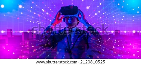 Digital community,Cryptocurrency and entertainment metaverse concept.male having fun play game VR virtual reality goggle in 3D cyberspace futuristic metaverse NFT and virtual reality city background