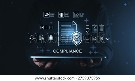 Digital compliance concept with checklist, document, security icons and business data graphics above hands holding tablet on dark gradient background
