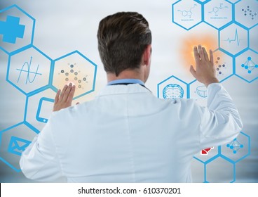 Digital composite of Back of man in lab coat touching blue medical interface with orange flares against grey background - Powered by Shutterstock - Get 15% off with code: PIKWIZARD15