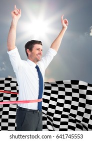 Digital Composite Of Business Man Cheering At Finish Line Against Sky And Sun And Checkered Flag