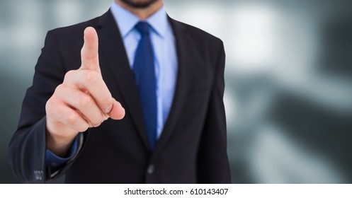 Digital composite of Business man mid section pointing in blurry grey room - Powered by Shutterstock