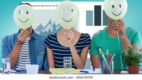 Digital composite of Casual business people holding balloons with smileys against graphs - Powered by Shutterstock