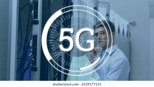 Digital composite of a Caucasian technician looking at a server while futuristic circles around a 5G moving in the screen - Powered by Shutterstock