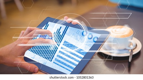 Digital composite of Close-up of hand using digital tablet with graph on screen