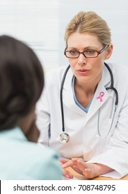 Digital composite of Doctor woman with breast cancer awareness ribbon and patient