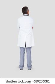 Digital Composite Of Full Body Portrait Of Doctor Man Standing With Grey Background