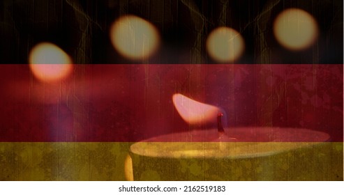 Digital Composite Of German Flag With Candles In The Background. One Candle Going Out 