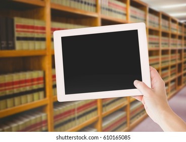 Digital composite of hand with tablet in Library
