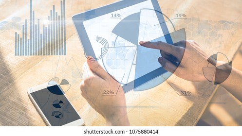 Digital composite of Hand using digital tablet with graphical overlay