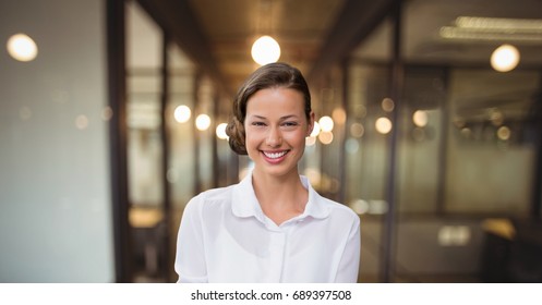 Digital Composite Of Happy Business Woman Standing Against Office Background