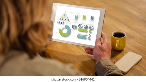 Digital composite of High angle view of businesswoman looking at graphs and chart in tablet computer while sitting by tab