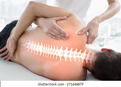 Digital composite of Highlighted bones of man at physiotherapy