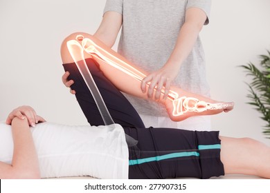 Digital composite of Highlighted bones of woman at physiotherapist - Powered by Shutterstock