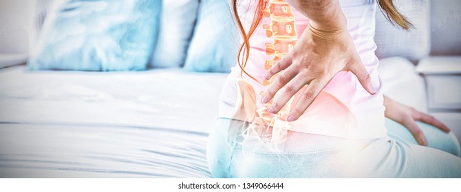 Digital Composite Of Highlighted Spine Of Woman With Back Pain At Home