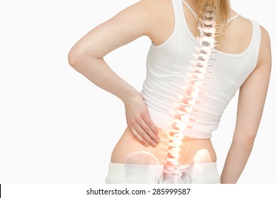 Digital Composite Of Highlighted Spine Of Woman With Back Pain