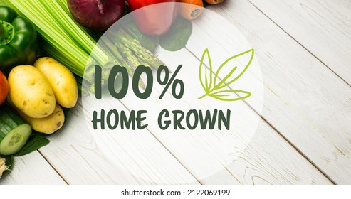 Digital composite image of 100 percent home grown symbol over fresh vegetables on wooden table. healthy food and sign, unaltered. - Powered by Shutterstock