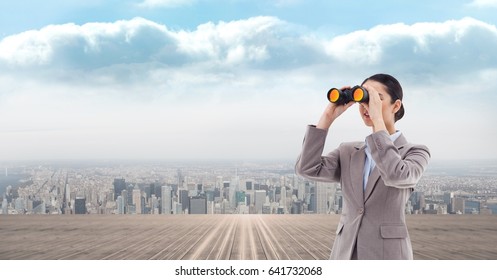 Digital composite of Digital composite image of businesswoman looking through binoculars - Powered by Shutterstock