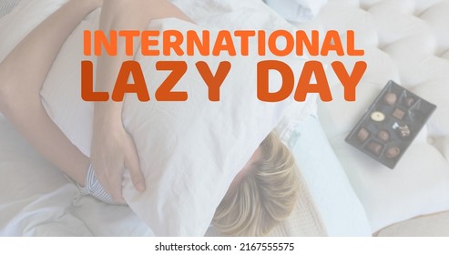 Digital Composite Image Of Caucasian Woman Hugging Pillow With International Lazy Day Text At Home. Copy Space, Relaxation, Celebrate Your Inner Couch Potato, Lazy Bums, Slackers.