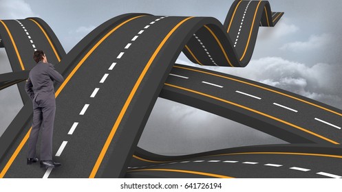 Digital composite of Digital composite image of confused executive standing on wavy road leading towards sky - Powered by Shutterstock