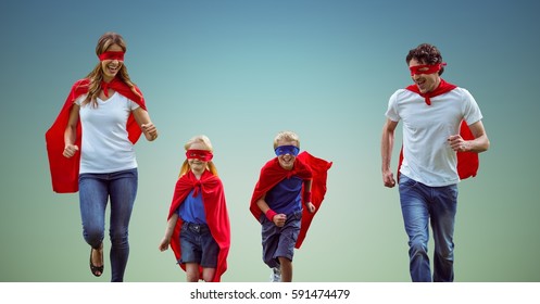 Digital composite image of family in superhero costume running together against sky blue background - Powered by Shutterstock