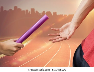 Digital composite image of hands passing the baton against cityscape background - Powered by Shutterstock