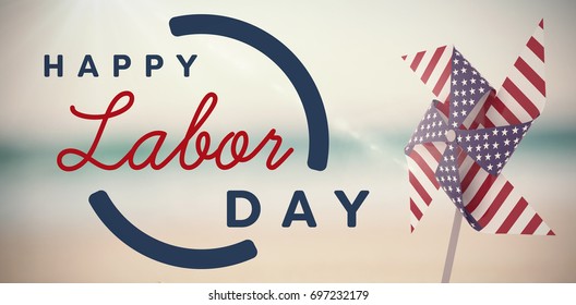 Digital composite image of happy labor day text with blue outline against pair of wedding ring on sand - Shutterstock ID 697232179