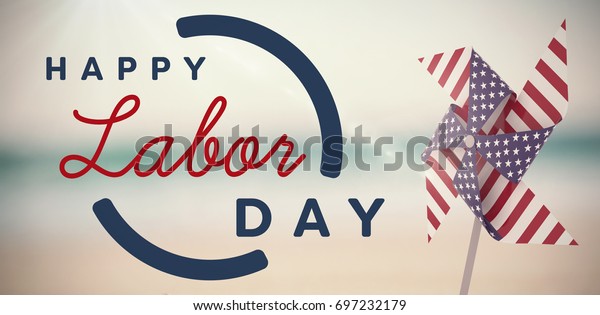 Digital composite image of\
happy labor day text with blue outline against pair of wedding ring\
on sand