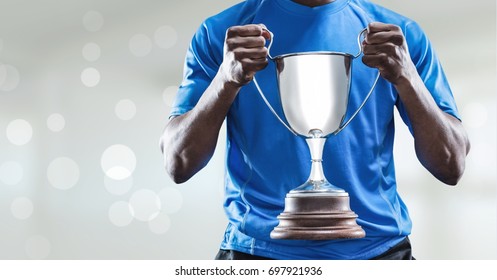 Digital composite of Man with a trophy on hands