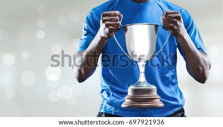 Digital composite of Man with a trophy on hands