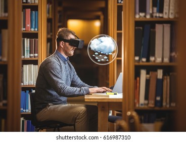 Digital composite of Man wearing VR Virtual Reality Headset with Interface and laptop - Powered by Shutterstock