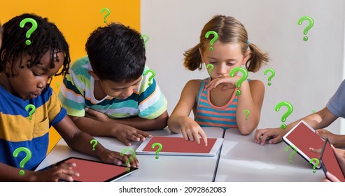 Digital composite of multiracial students using tablet pcs at desk in classroom with question marks. education and knowledge.