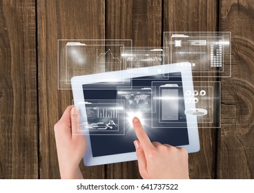 Digital composite of Overhead of hands with tablet and white interface with flare