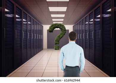 Digital composite of Rear view of businessman looking at question mark