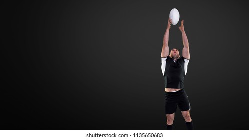 Digital composite of Rugby player jumping for ball with blank black background - Powered by Shutterstock