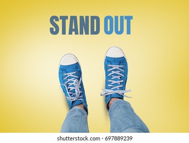 Digital composite of Stand out text and Blue shoes on feet with yellow background