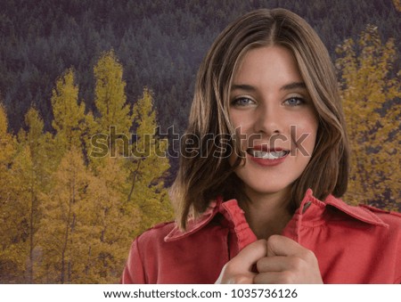 Digital composite of Woman in Autumn with jumper tight in forest