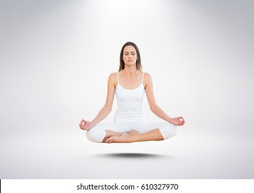 Digital composite of Woman Meditating floating against grey background