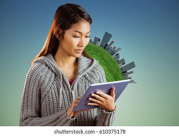 Digital composite of Woman with tablet against globe and buildings and blue green background - Powered by Shutterstock