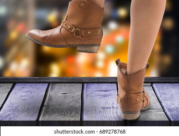 Digital composite of Woman's feet with Party boots  over night city